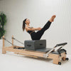 Woman stretching on a pilates reformer