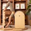Woman exercising on Pilates Barrel and Arc